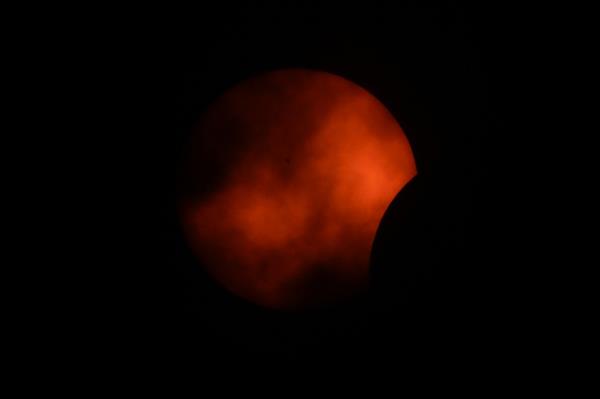 Clouds rolling by during the beginning of the eclipse in Arlington, Texas on April 8, 2024.