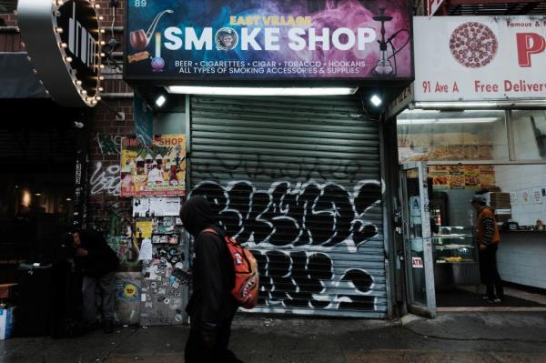 Closed smoke shop in New York's East Village, signifying city's crackdown on unlicensed cannabis dispensaries