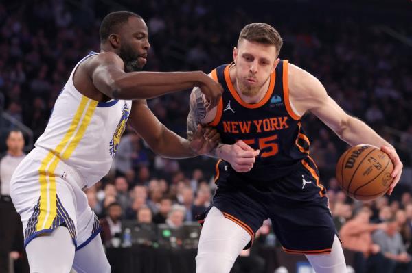 Knicks center Isaiah Hartenstein (55) controls the ball against Golden State Warriors forward Draymond Green (23) during the first quarter.