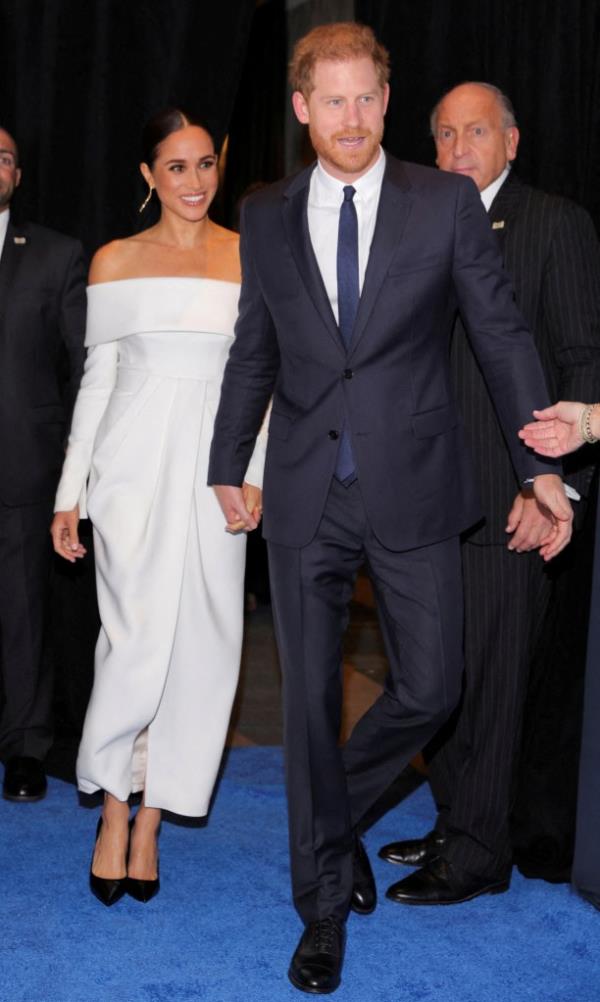 Meghan and Harry hold hands at an event in 2022.