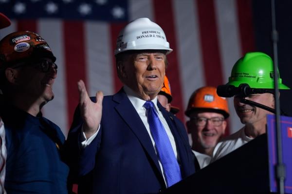 Republican presidential nominee former President Do<em></em>nald Trump stands on stage with steelworkers as he speaks during a campaign rally at Arnold Palmer Regio<em></em>nal Airport, Saturday, Oct. 19, 2024, in Latrobe, Pa.