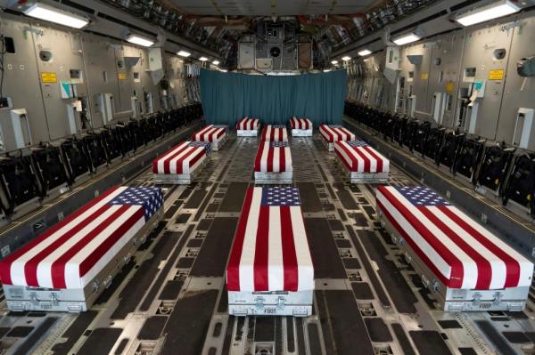 Flag-draped transfer cases of U.S. military service members who were killed by an August 26 suicide bombing at Kabul's Hamid Karzai Internatio<em></em>nal Airport line the inside of a C-17 Globemaster II prior to a dignified transfer at Dover Air Force ba<em></em>se, Delaware on August 29, 2021.