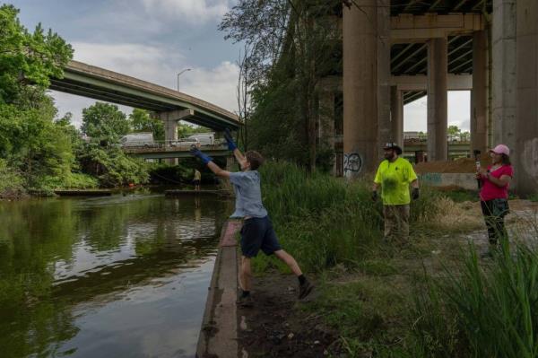 A person near a river casting as James Kane and Barbie Agostino look on