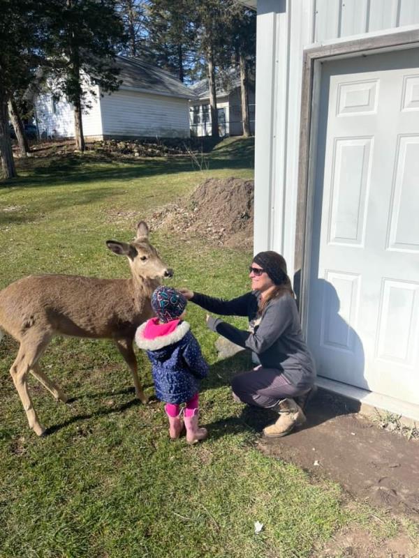 Annie is pictured with a mother and her young daughter at the property.