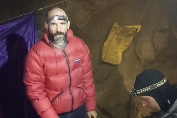 Speleologist Mark Dickey, delivering a video message as he waits to be rescued after falling gravely ill in the depths of the earth while co<em></em>nducting cave research.