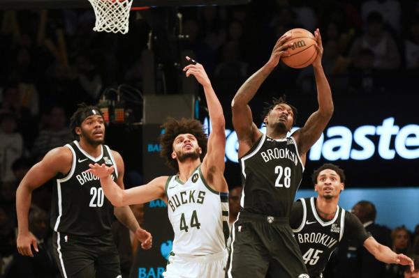 The Nets' Dorian Finney-Smith grabs the rebound past the Bucks' Andre Jackson Jr. during the second half of a game Sunday, Dec. 8, 2024, at Barclays Center.