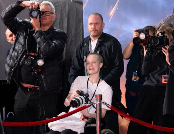 Liz Hatton (C) works alo<em></em>ngside the press photographers during the UK Premiere of 