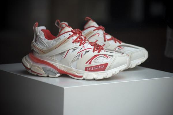 Closeup of red and white sneakers by the famous italian brand Balenciaga in a fashion store showroom