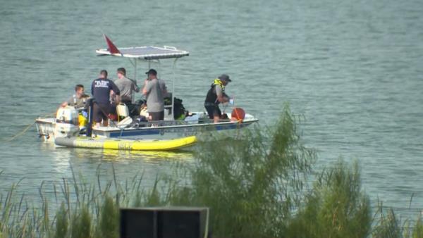 Authorities searching the lake by boat.