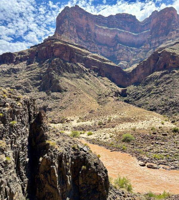 A view of part of the Grand Canyon in Arizona shows cliffs towering over a trail.