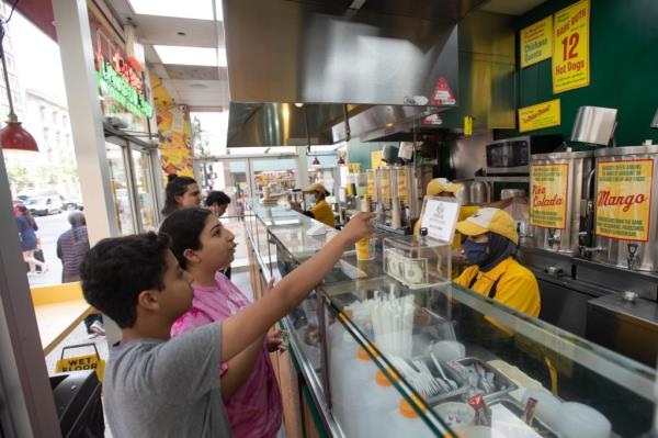 The tiny shop offered famously good deals on their hotdogs and tropical drinks out of its tiny Upper East Side shop