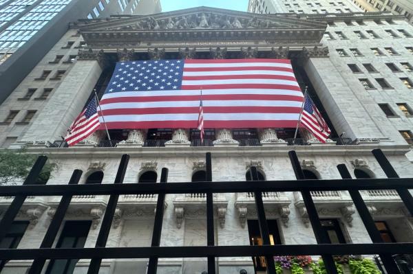 American flag hanging from the front of the New York Stock Exchange building.