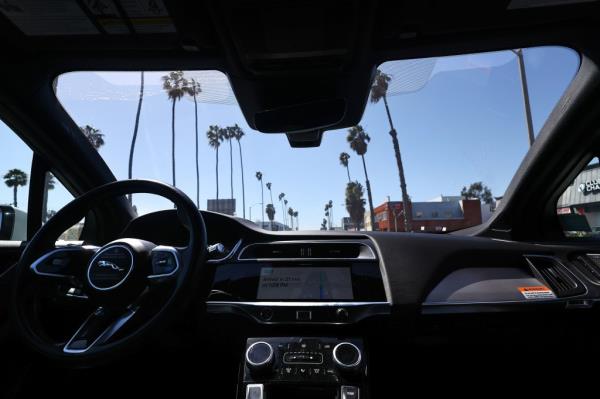 A Waymo auto<em></em>nomous self-driving Jaguar taxi drives along a street on March 14, 2024 in Santa Monica, California.