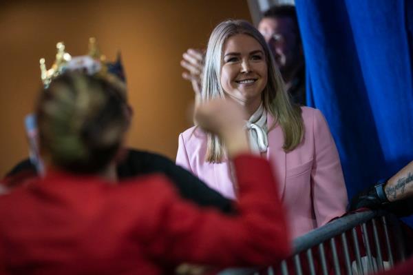 Karoline Leavitt listening to former President Do<em></em>nald Trump speaking at a campaign event in DoubleTree Manchester Downtown, April 27, 2023