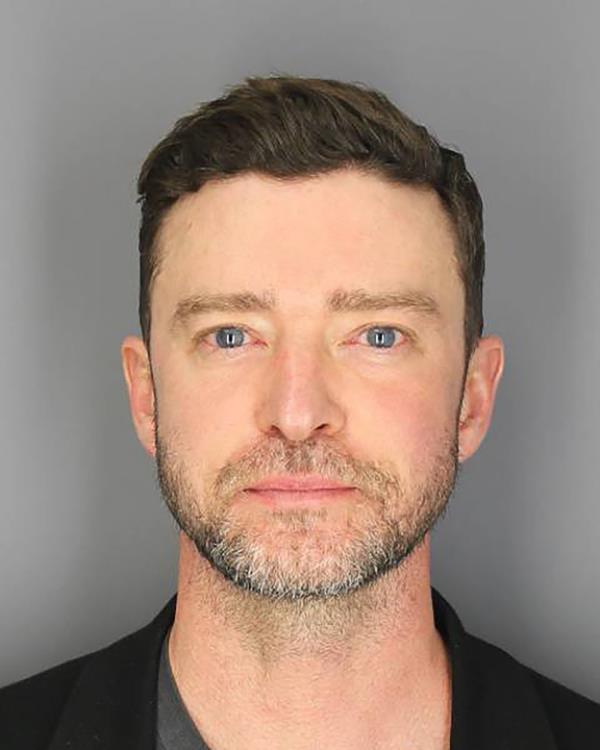 mug shot of justin timberlake with grey background.