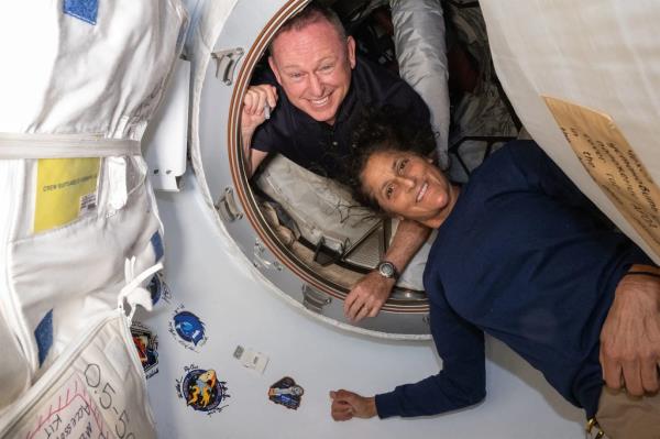 This undated handout picture from Nasa released on July 2, 2024 shows NASA's Boeing Crew Flight Test astro<em></em>nauts (from top) Butch Wilmore and Suni Williams inside the vestibule between the forward port on the Internatio<em></em>nal Space Station's Harmony module and Boeing's Starliner spacecraft.