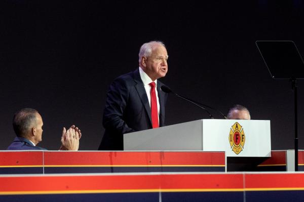 Democratic vice presidential nominee, Minnesota Gov. Tim Walz speaks on stage during the Internatio<em></em>nal Association of Fire Fighters (IAFF) Co<em></em>nvention on August 28, 2024 in Boston, Massachusetts. 