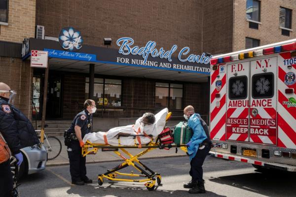 New York City Fire Department (FDNY) Emergency Medical Technicians (EMT) wearing perso<em></em>nal protective equipment lift a man after moving him from a nursing home into an ambulance during an o<em></em>ngoing outbreak of the coro<em></em>navirus disease (COVID-19) in the Brooklyn borough of New York, U.S., April 16, 2020.