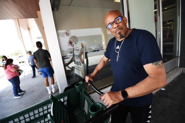 A photo of Ellis Olive with a shopping cart.