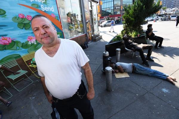 A photo of Manny Grima on a street in Queens.