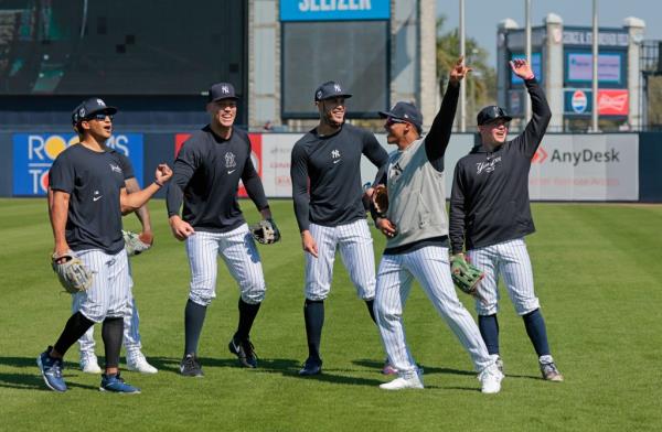 Trent Grisham #12, Aaron Judge #99, Giancarlo Stanton #27, Juan Soto #22 and Alex Verdugo #24, celebrating after Soto threw a ball to a fan who caught it, during practice at Steinbrenner Field.