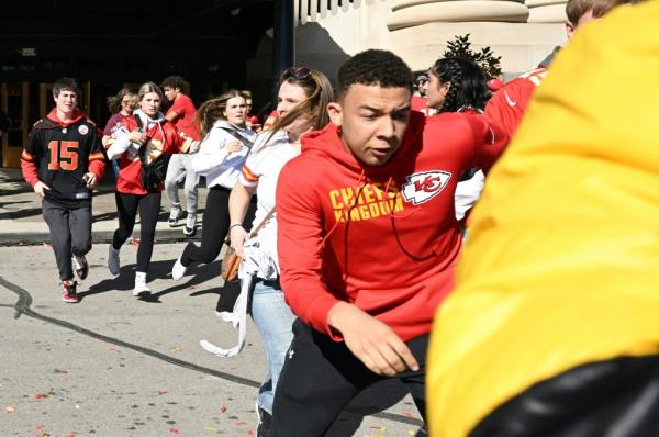 People flee after shots were fired near the Kansas City Chiefs' Super Bowl LVIII victory parade on February 14, 2024, in Kansas City, Missouri. 