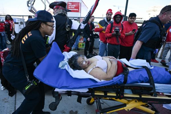 An injured person is taken to an ambulance near the Kansas City Chiefs' Super Bowl LVIII victory parade on February 14, 2024, in Kansas City, Missouri. 