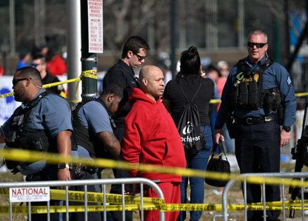 A victim is aided after shots were fired near the Kansas City Chiefs' Super Bowl LVIII victory parade.