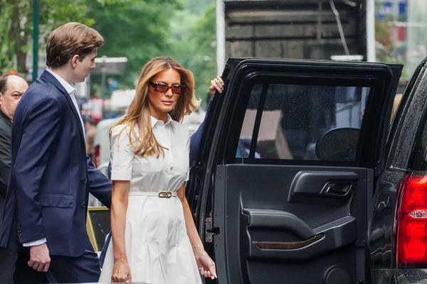 Melania Trump and Barron entering a Secret Service SUV