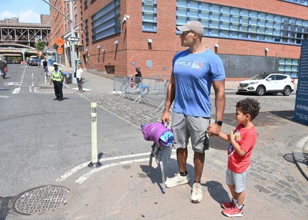 Kenny U. Grant and son Hudson,4, outside the Peck Slip School, P.S. 343,  wher<em></em>e his son is a student.   