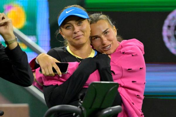 Paula Badosa (L) and Aryna Sabalenka watch action in the Eisenhower Cup Tie Break Tens event featuring mixed doubles during the BNP Paribas Open at the Indian Wells Tennis Garden on March 5, 2024. 