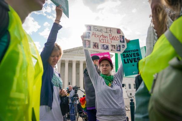 Activists protest outside the Supreme Court during a high-stakes abortion case.