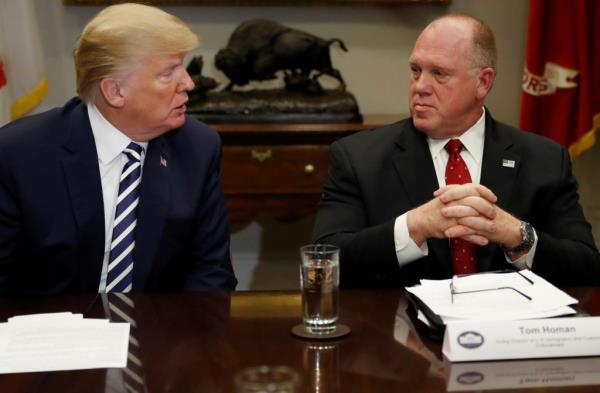 Do<em></em>nald Trump and Tom Homan in suits at a nice table.