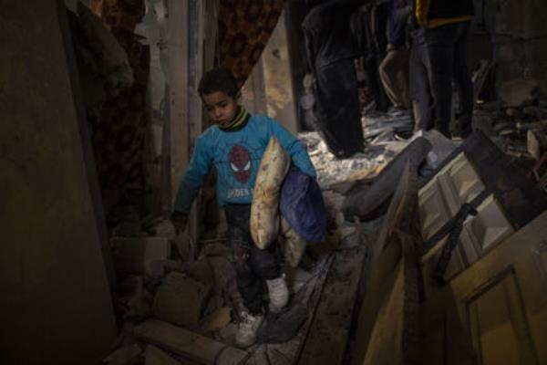 Palestinians collect their belo<em></em>ngings from their damaged house after an Israeli airstrike in Rafah, southern Gaza Strip. Picture: AP Photo/Fatima Shbair