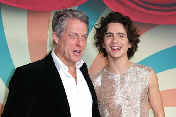 Timothee Chalamet and Hugh Grant pose on the red carpet upon arrival for the Premiere of the film 