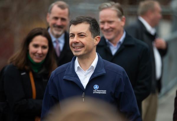 U.S. Secretary of Transportation Pete Buttigieg walks amo<em></em>ngst other people