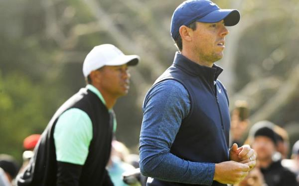 Tiger Woods (L) and Rory McIlroy of Northern Ireland watch a shot on the 2nd hole during the co<em></em>ntinuation of the first round of the Genesis Open at Riviera Country Club on February 15, 2019 in Pacific Palisades, California